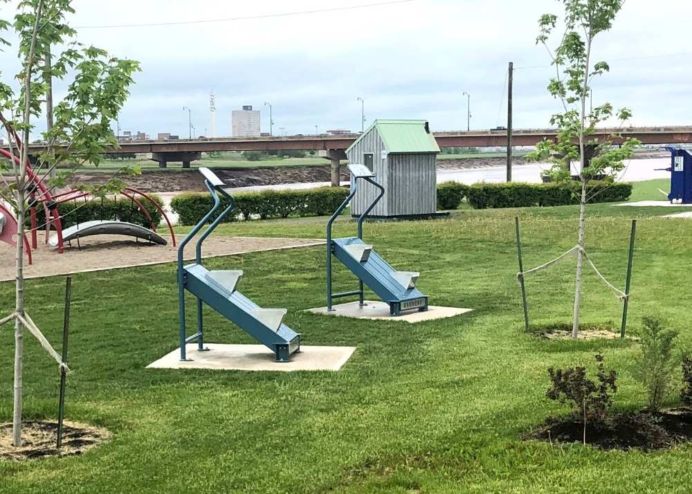 Metal stair climbers next to children's playground equipment