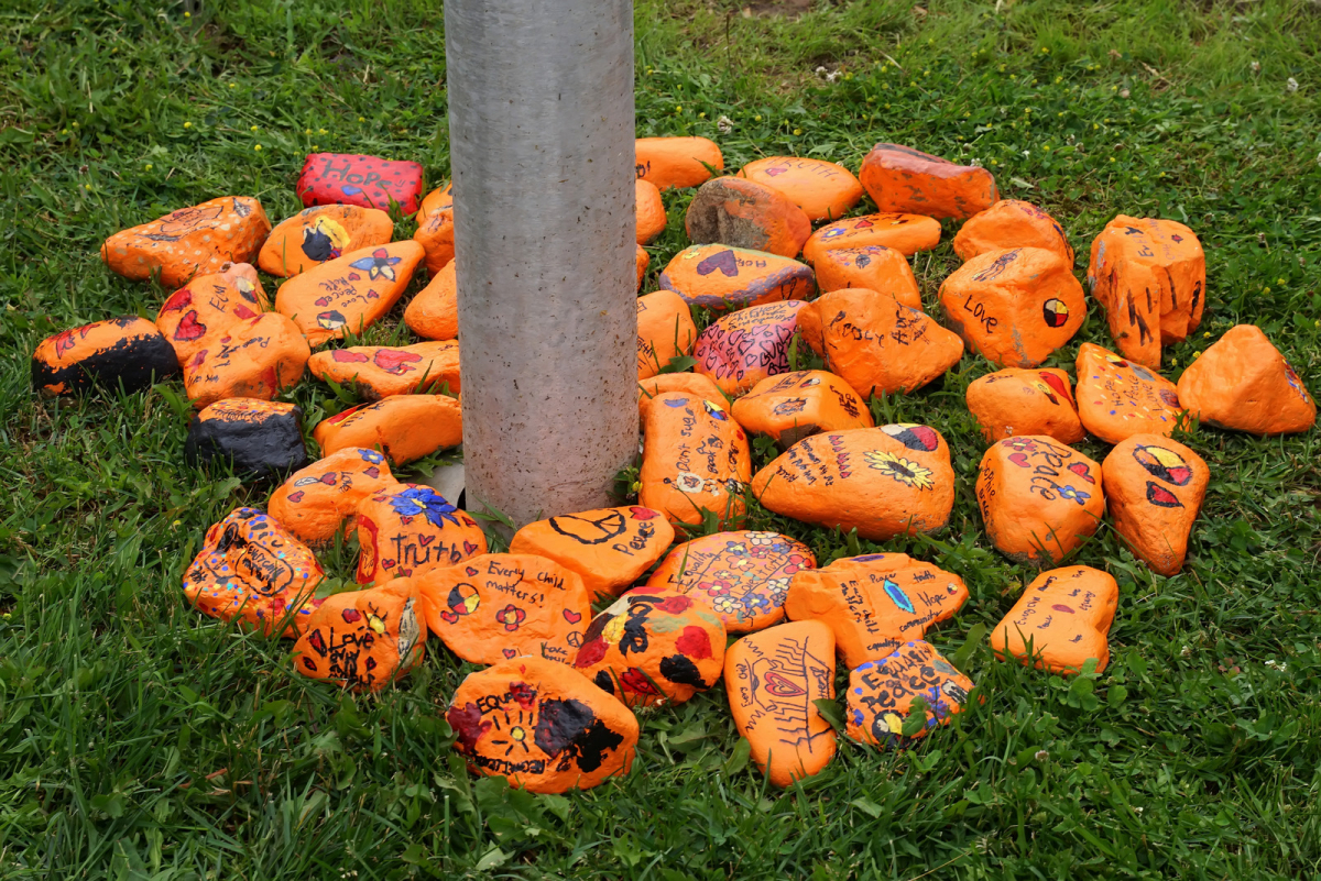 Elementary school students painted rocks orange with messages of peace to honour missing indigenous children