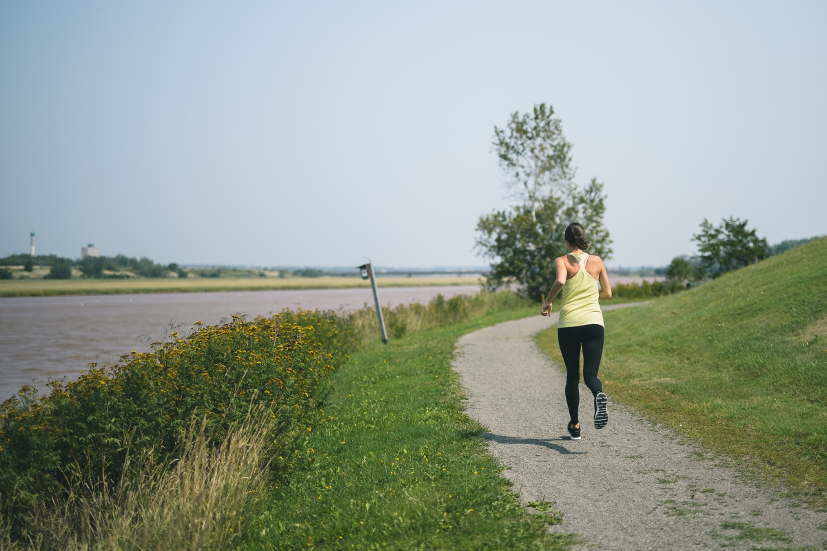 Woman running along a multi-use trail
