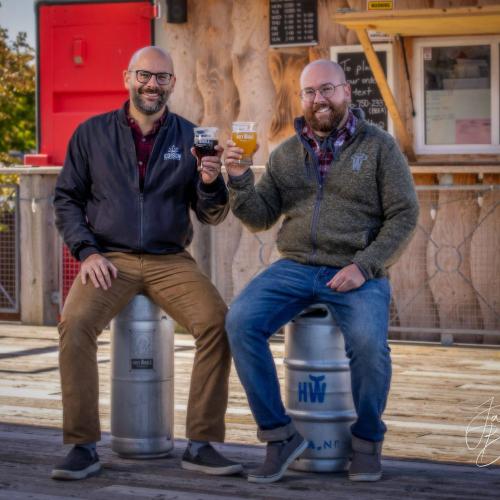 Pete and Jeff Grandy cheers a beer on the patio of Holy Whale Beer Hall