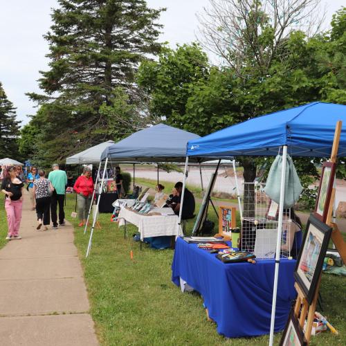 Booths along a riverfront trail