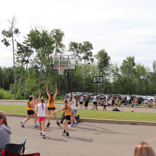 A team of youth playing basketball outside
