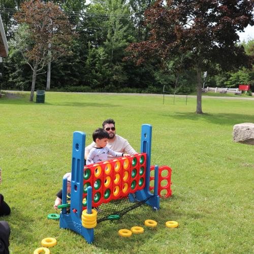 A family playing a giant connect 4 game