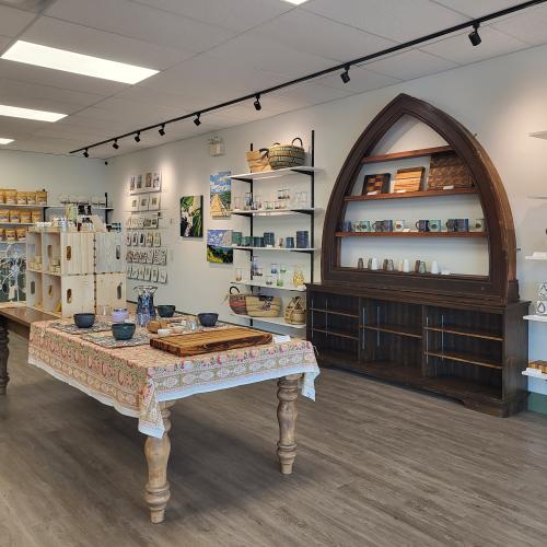 Tables and shelving with giftware and artwork displayed. 