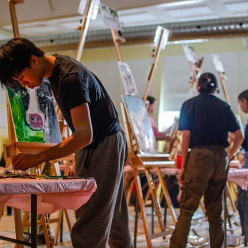 Youth painting in an art battle