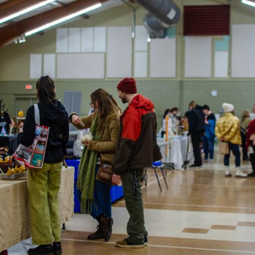 People at an indoor market shopping
