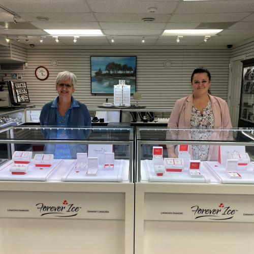 2 female employees behind the jewelry case in the Inglis Jewellers Riverview store.tore