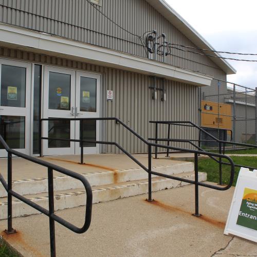 The stairs leading up to a double door entrance community building