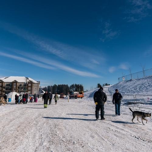 The bottom of a sliding hill with people walking
