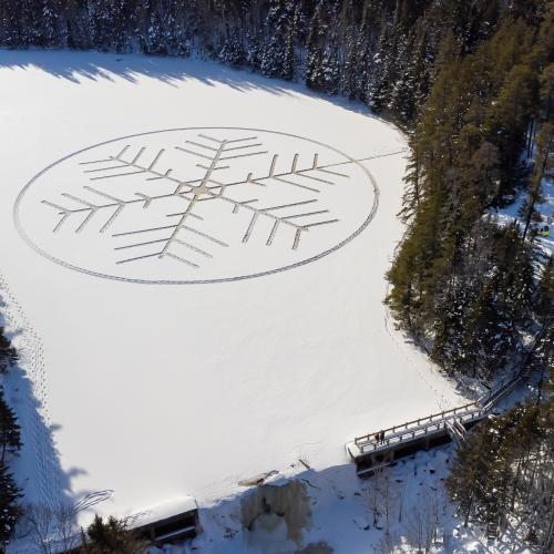 A snowflake impression made on a snowy ice pond
