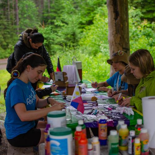 People doing crafts at a picnic table