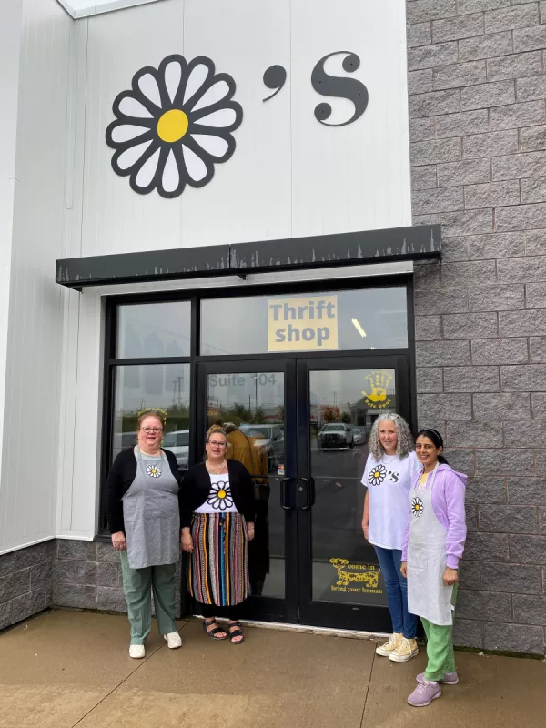 Staff of Dayzee's Thrift Store standing outside business