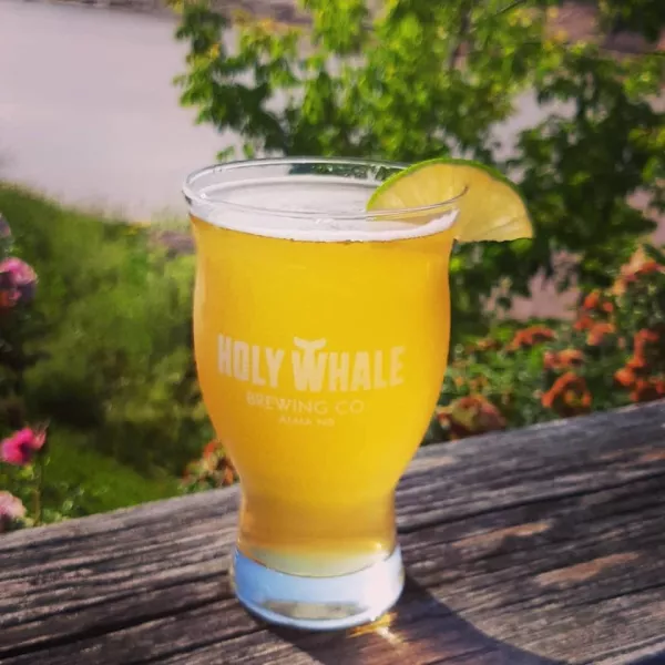 A glass of beer with a lime wedge