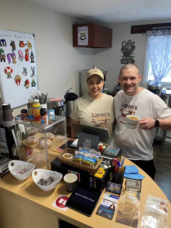 Owners standing inside of coffee shop
