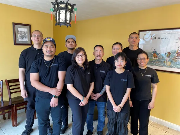 Staff smiling together inside restaurant
