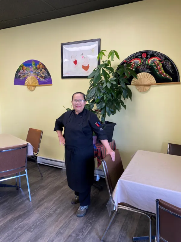 Owner smiling inside Royal Thai Restaurant