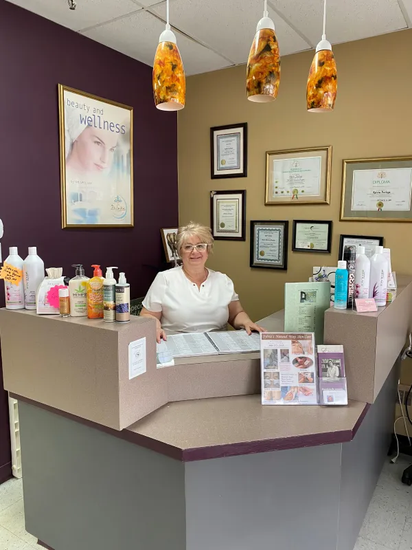 Sylvia Furlaga standing behind the desk at her salon
