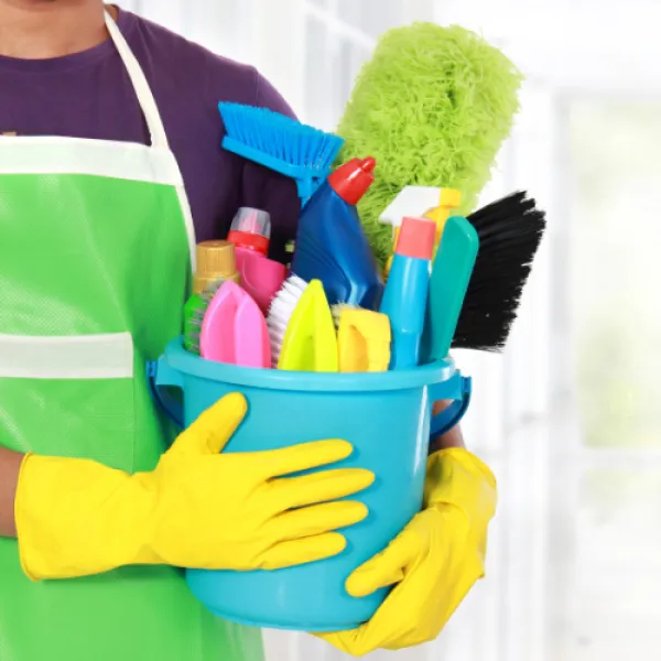 Person holding a bucket of cleaning supplies