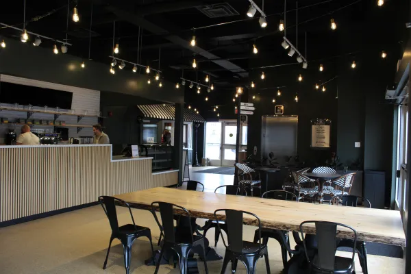 An indoor cafe with overhead lights and comfortable seating