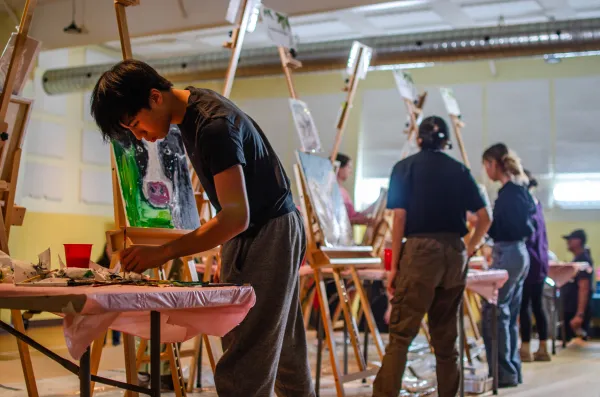 Youth painting in an art battle