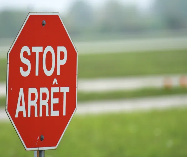 A French/English bilingual red stop sign 