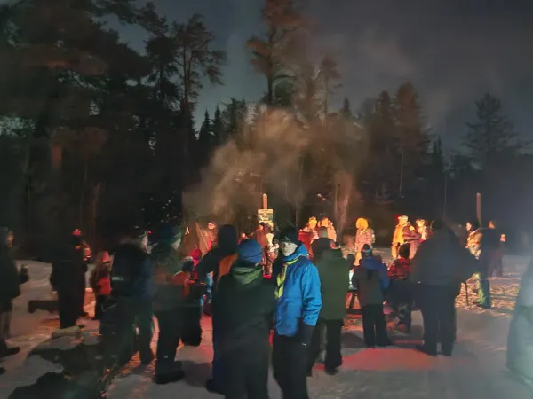 People gathered around a campfire in Mill Creek Nature Park.