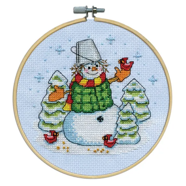 Cross stitch pattern of a snowman and trees.