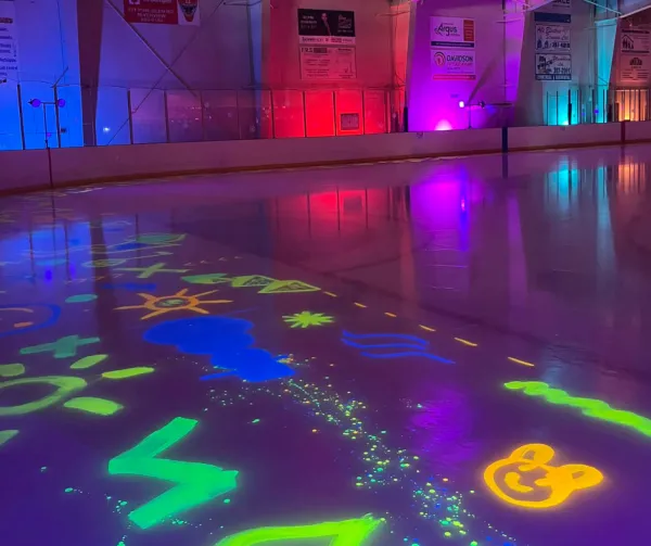 Byron Dobson Winter Carnival Glow Skate with ice painted in neon colors and black lights
