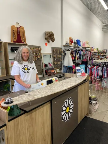 Owner of Dayzee's thrift store standing behind counter