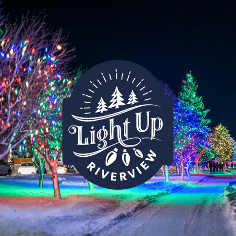 The Light Up Riverview logo appears over a photo of a snow-covered Riverfront Trail with trees lit an array of colours