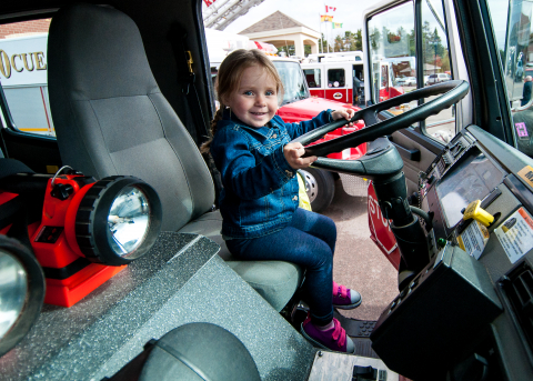 Girl behind wheel of fire truck