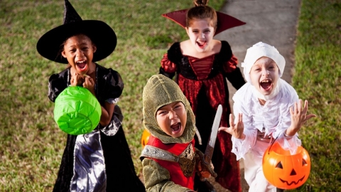 Four kids trick-or-treating in costume