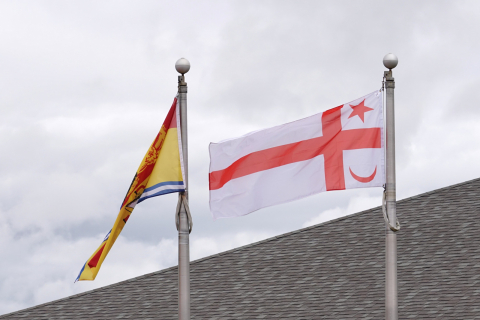 mi'kmaq grand council flag flies outside riverview town hall next to new brunswick provincial flag