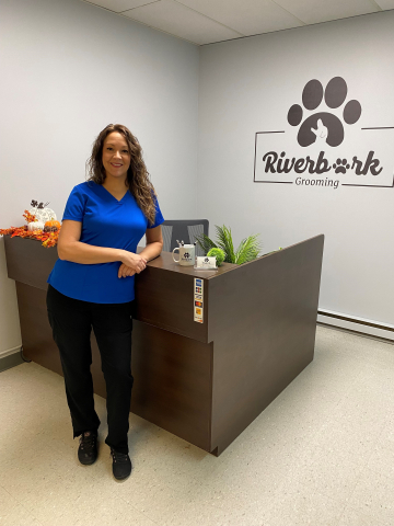 Riverbark Grooming owner standing by reception desk