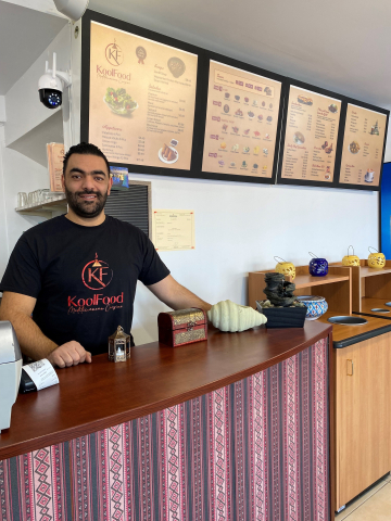 KoolFood owner standing behind counter