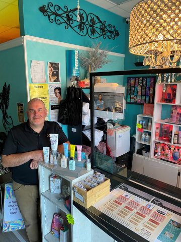 Salon owner standing next to counter