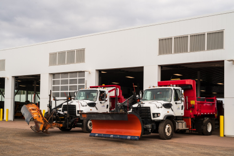 Two snow plows parked in public works garage