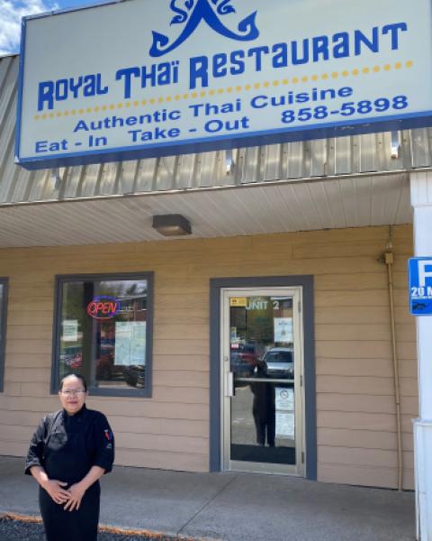 Owner of Royal Thai restaurant standing outside storefront