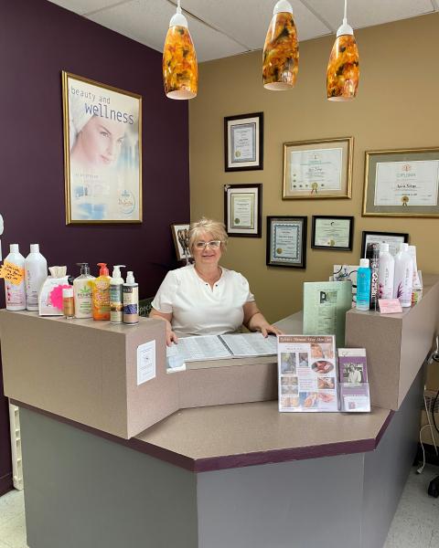 Sylvia Furlaga standing behind the desk at her salon