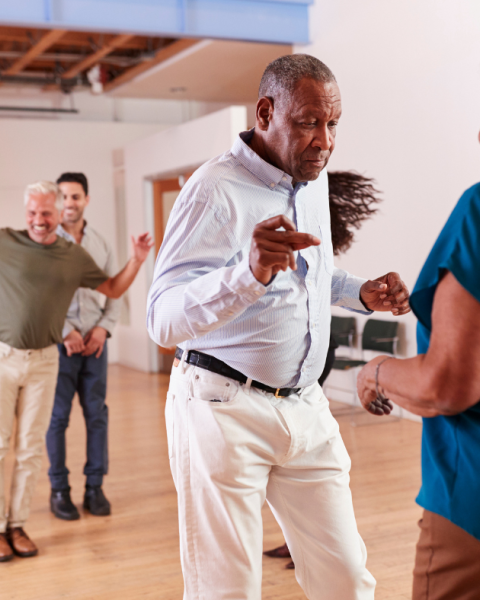 Seniors dancing in a community hall