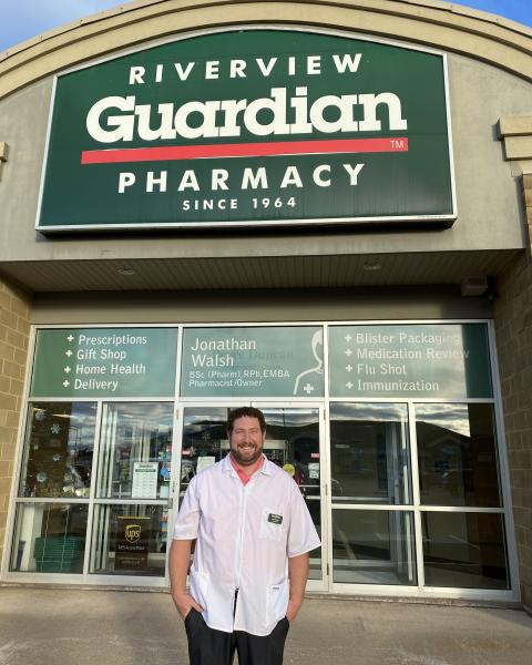 Owner stands outside of the pharmacy