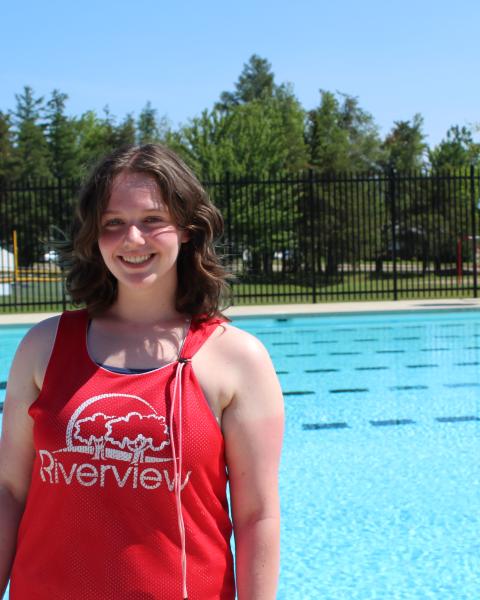 Lifeguard stands beside outdoor pool