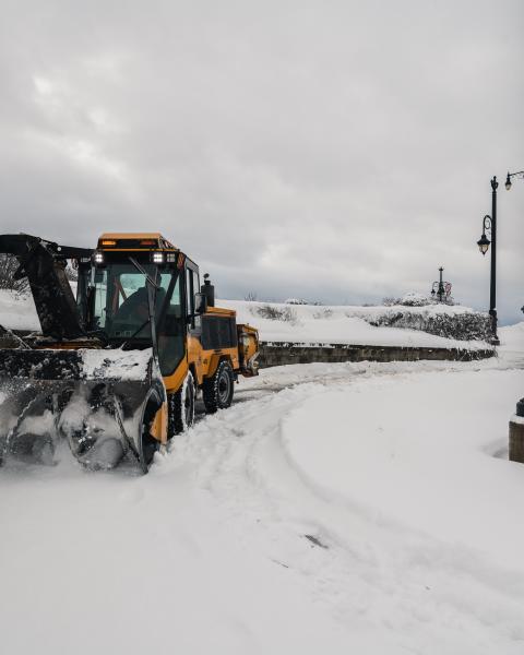 Snow plow clears snow off sidewalk by gunningsville bridge