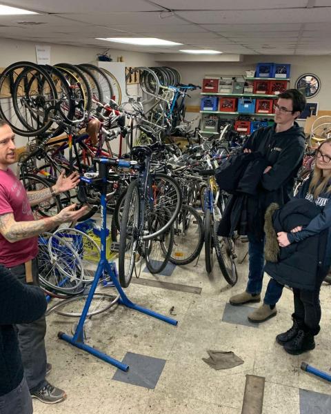 People receiving instruction on bike repair