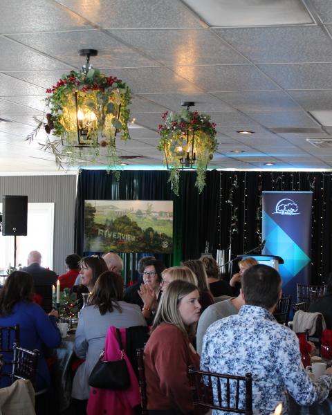 A formally decorated dining room filled with people