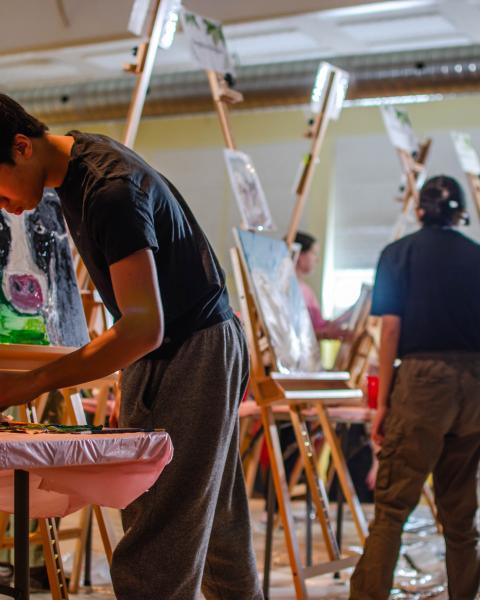 Youth painting in an art battle