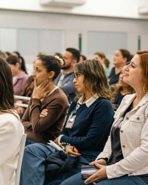 Women sitting in crowd at a conference event