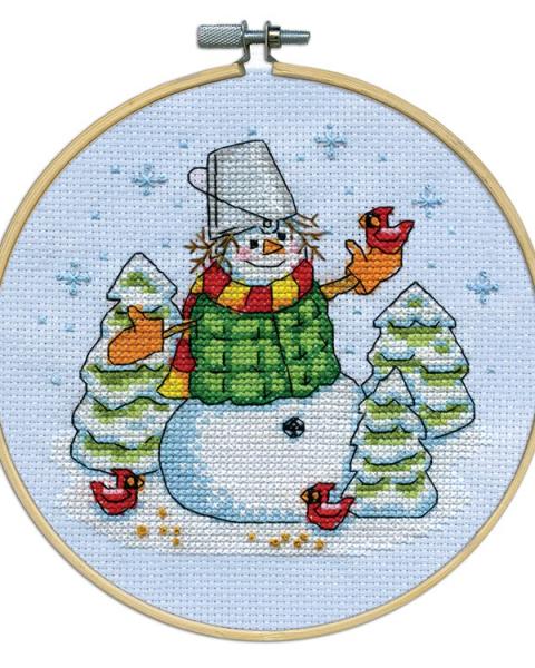 Cross stitch pattern of a snowman and trees.