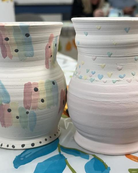 2 painted pottery mugs side by side