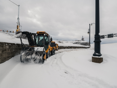 Snow plow clears snow off sidewalk by gunningsville bridge